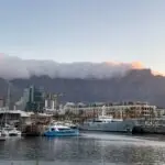 Cape town waterfront at sunset, South Africa. Yachts at harbor, Clouds over Table mountain summit