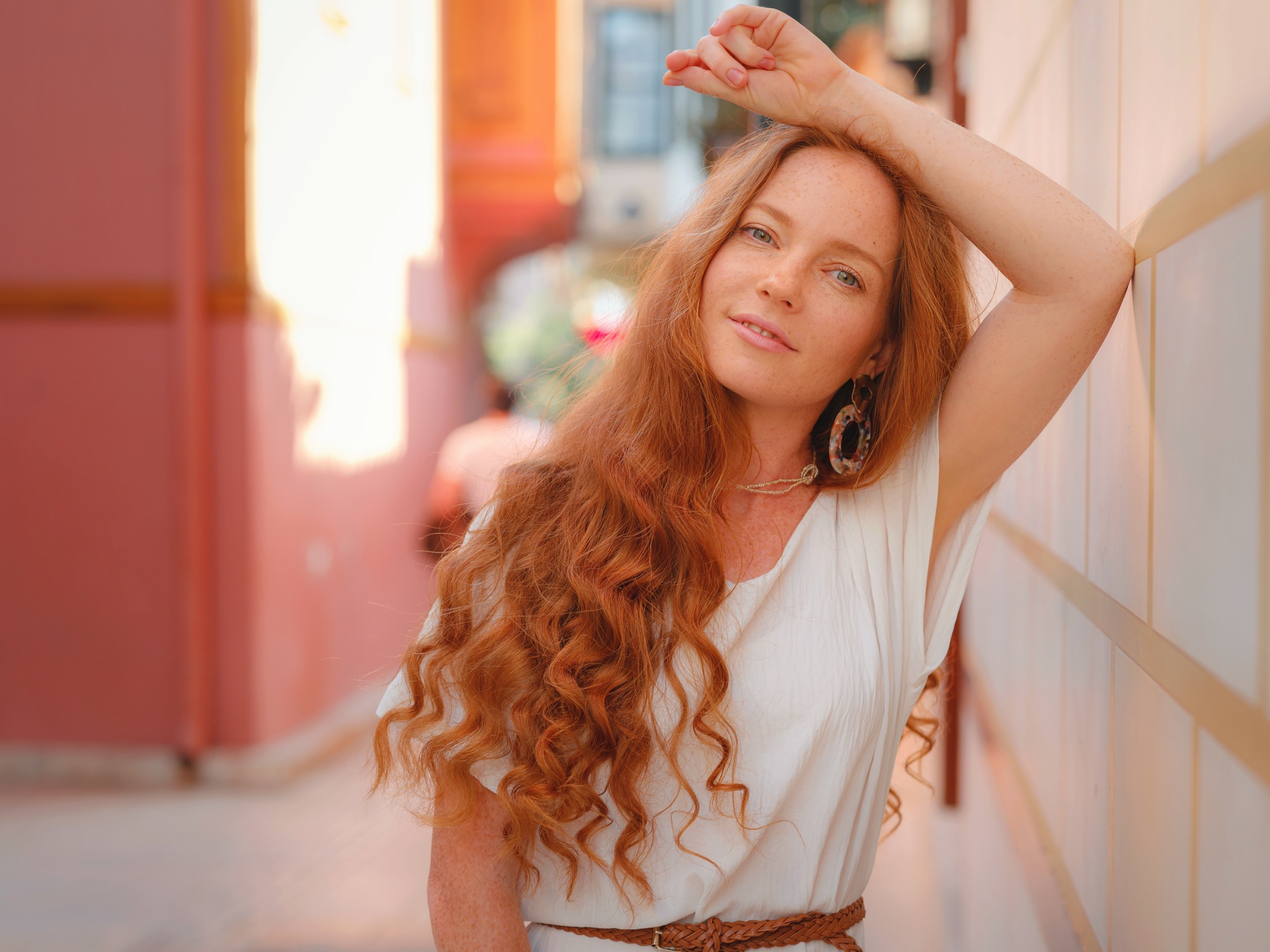 Happy woman tourist on blooming street of Antalya