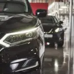 The headlights and the hood of a black luxury car