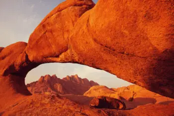 Colorful landscapes of the orange rocks in the mountains in Namibia on a sunny hot day.