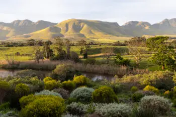 View across a tranquil landscape, river valley and a mountain range