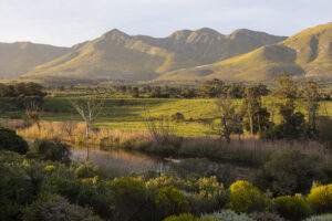 View across a tranquil landscape, river valley and a mountain range